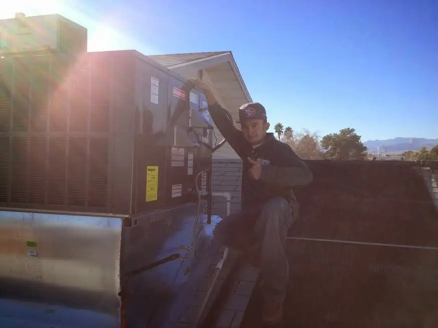 HVAC technician performing HVAC Inspection on a rooftop unit in East Donegal